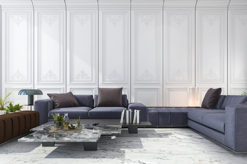 Moderner Wohnbereich mit weißen Zierpaneelen, grauem Ecksofa, Marmor-Couchtisch und indirekter Beleuchtung – Stuckarbeiten